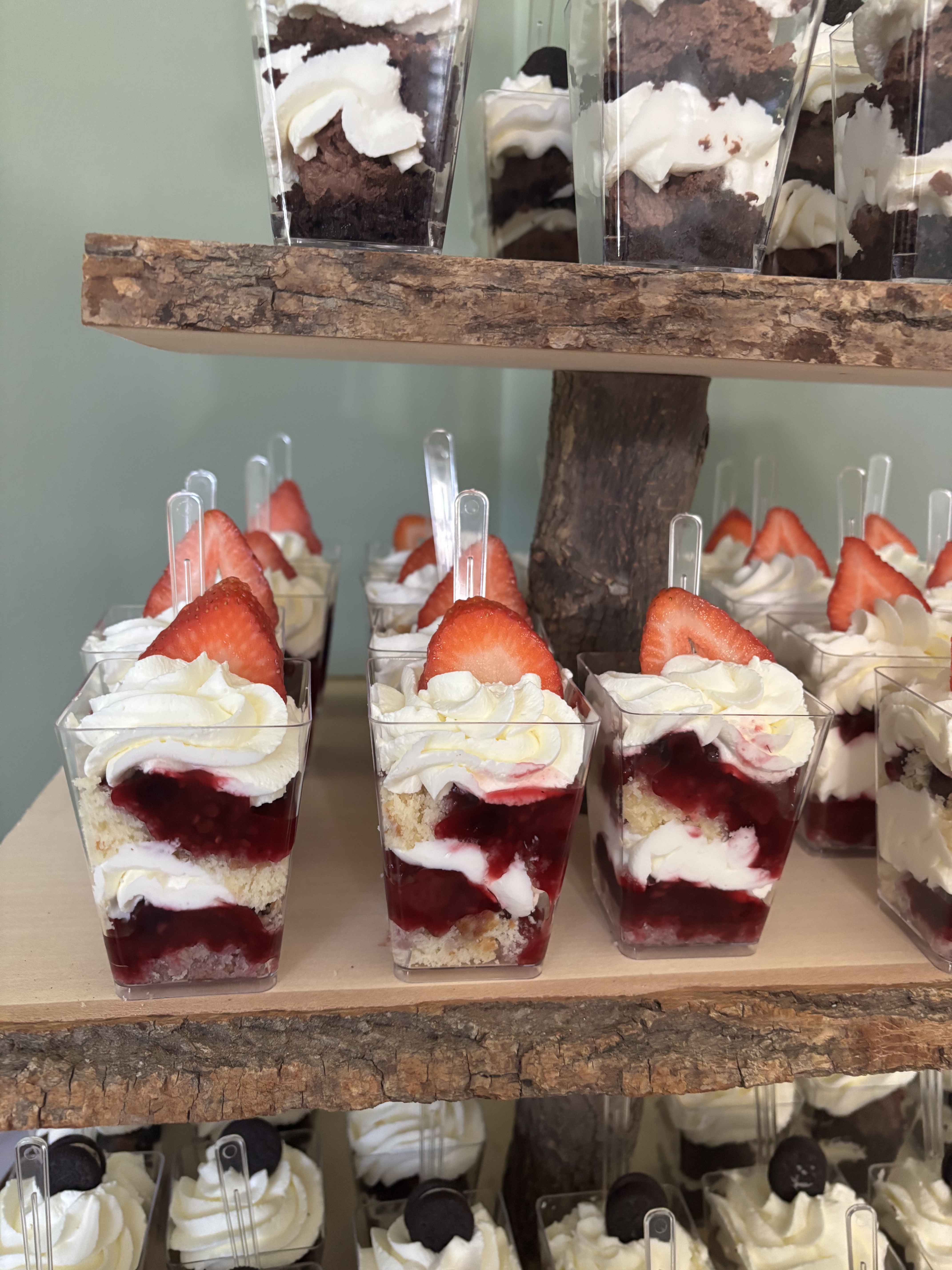 Multi-tiered dessert display with strawberry and Oreo parfaits for a catered event